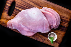 raw chicken breast on board