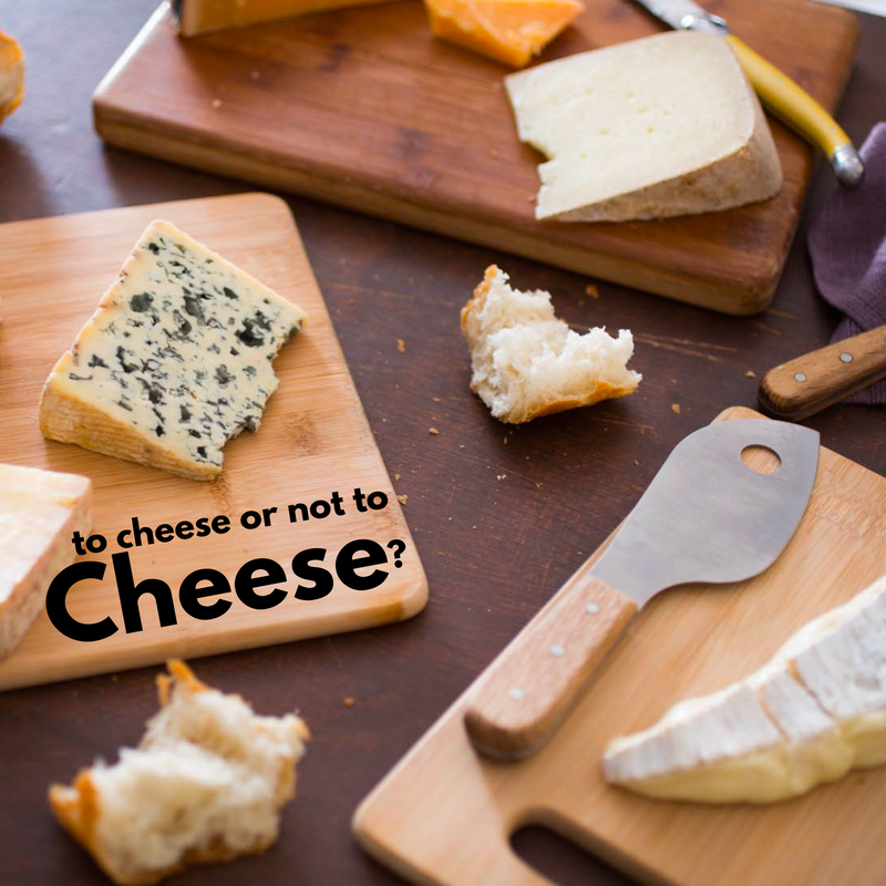 A picture of a few cheese slices on boards with knives and black text "to cheese or not to cheese?"